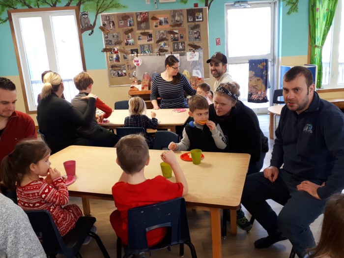 Parents with kids are sitting at the tables in EarlyON Years Centre